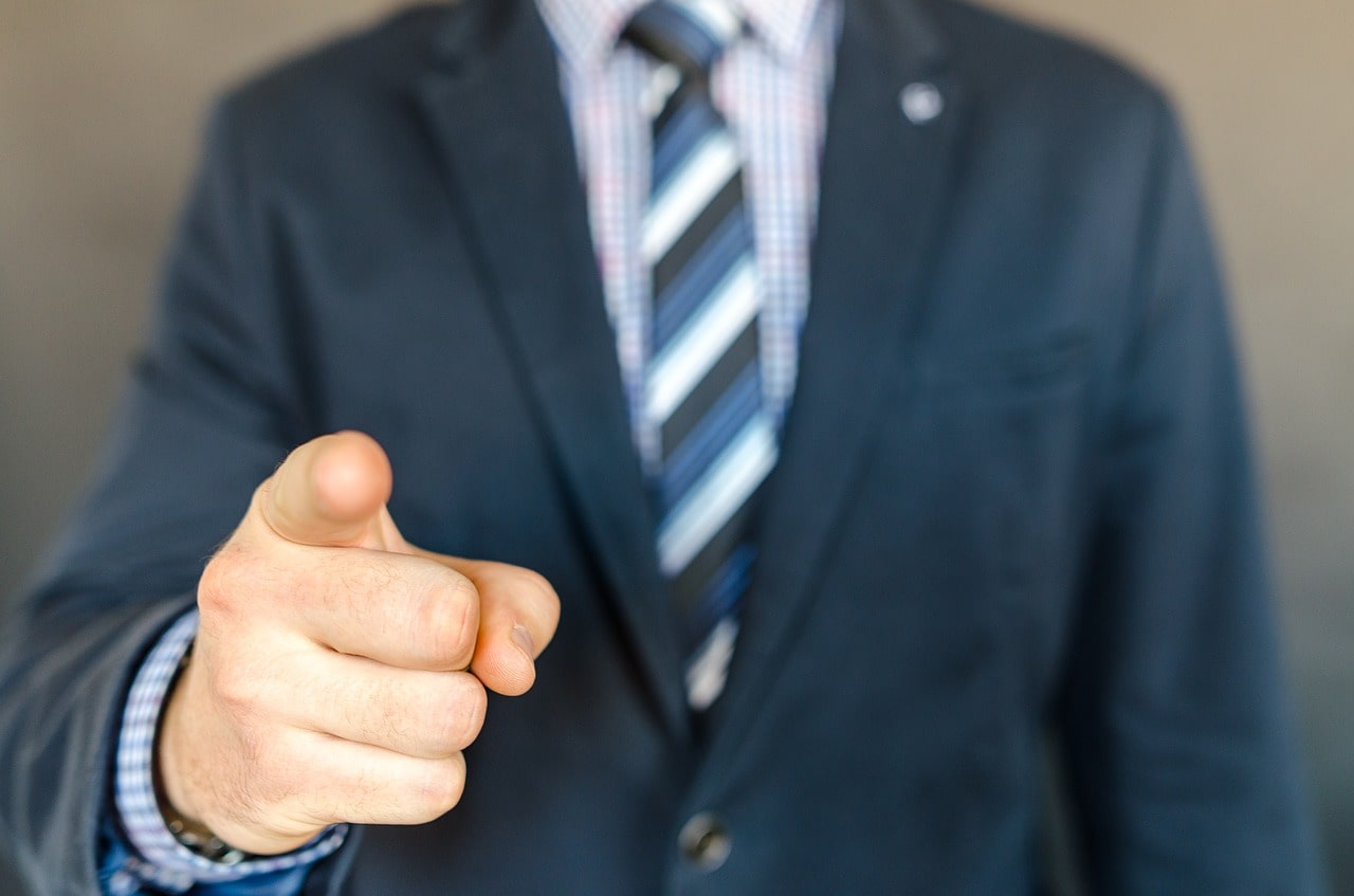 businessman pointing at camera